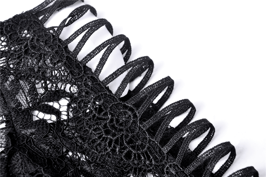 Close-up of intricate black lace detailing on a Gothic bolero, showcasing elegant patterns and textures.