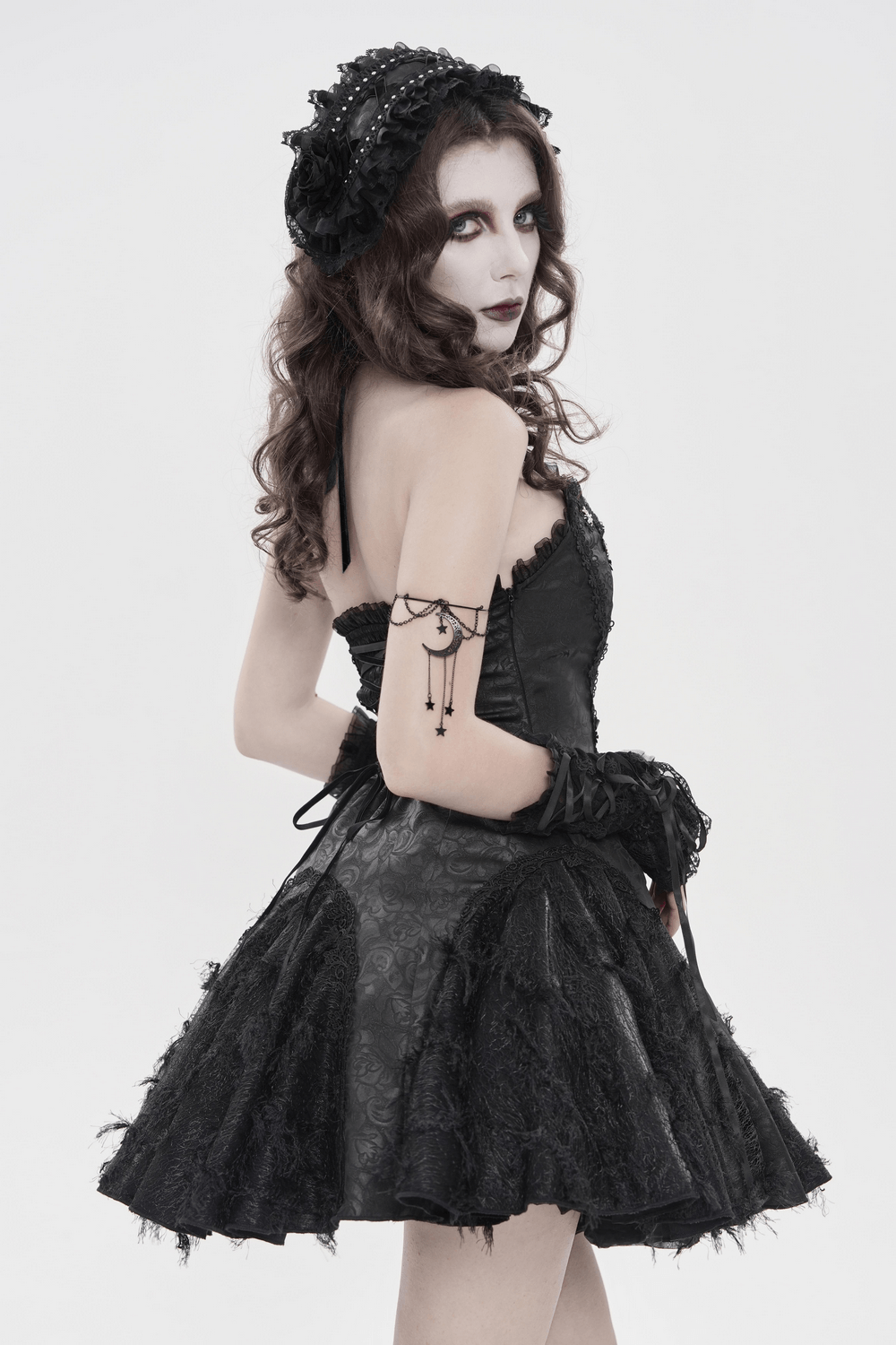 Gothic Lace Bonnet Headpiece with Rose Details worn by a model in a stunning black dress.