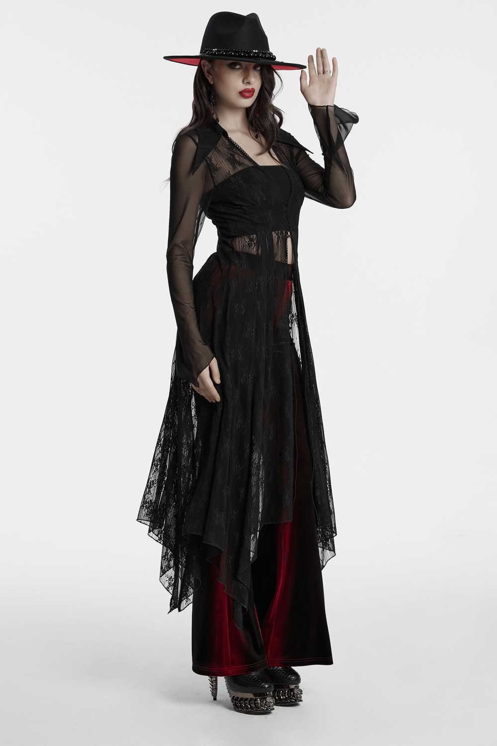 Gothic lace cape with drawstring and irregular hem worn by a model in a stylish black and red outfit.