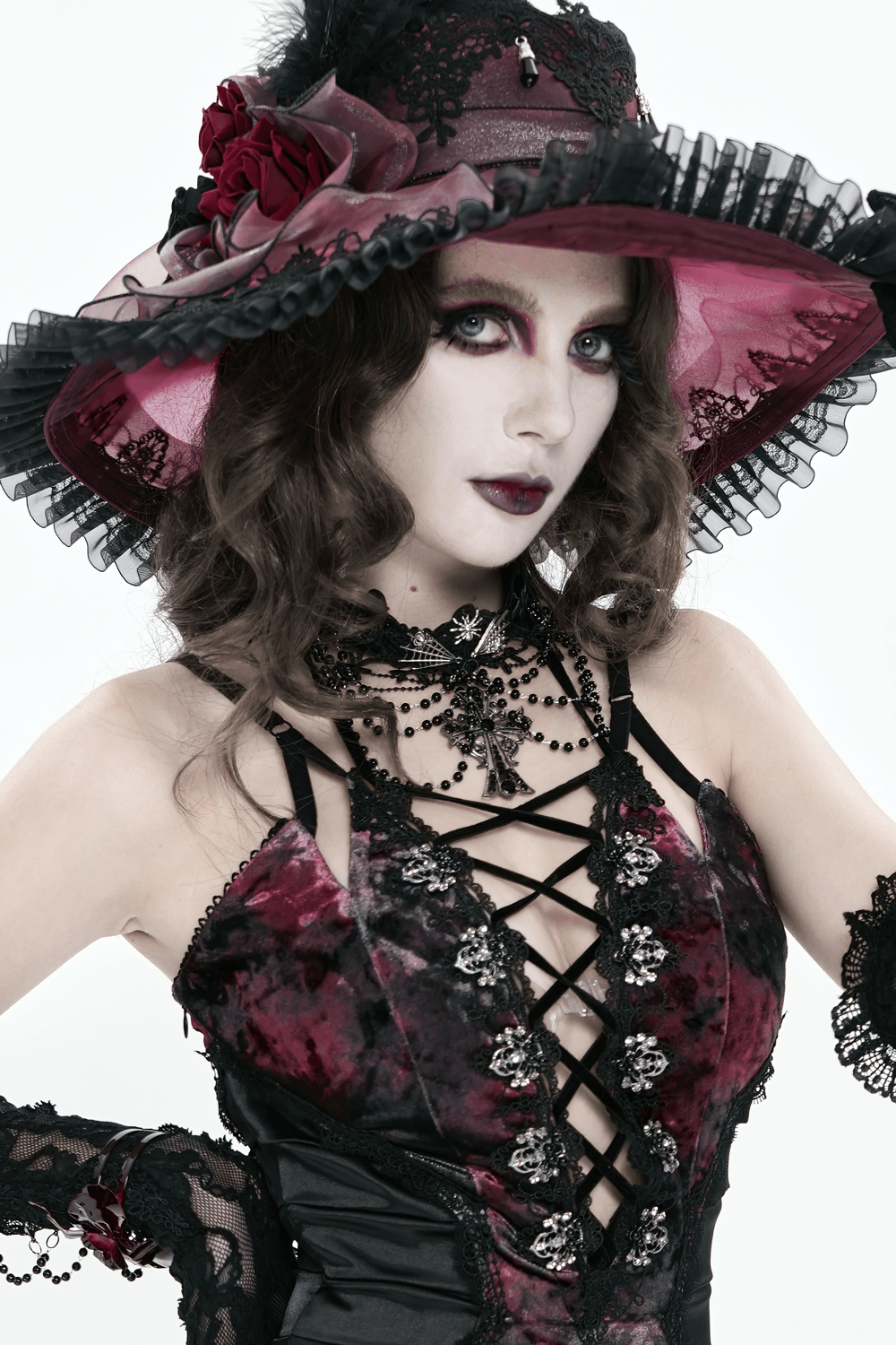 Gothic Lace Choker Necklace with Cross Pendant worn by model in dark romantic attire with a striking hat and dramatic makeup.