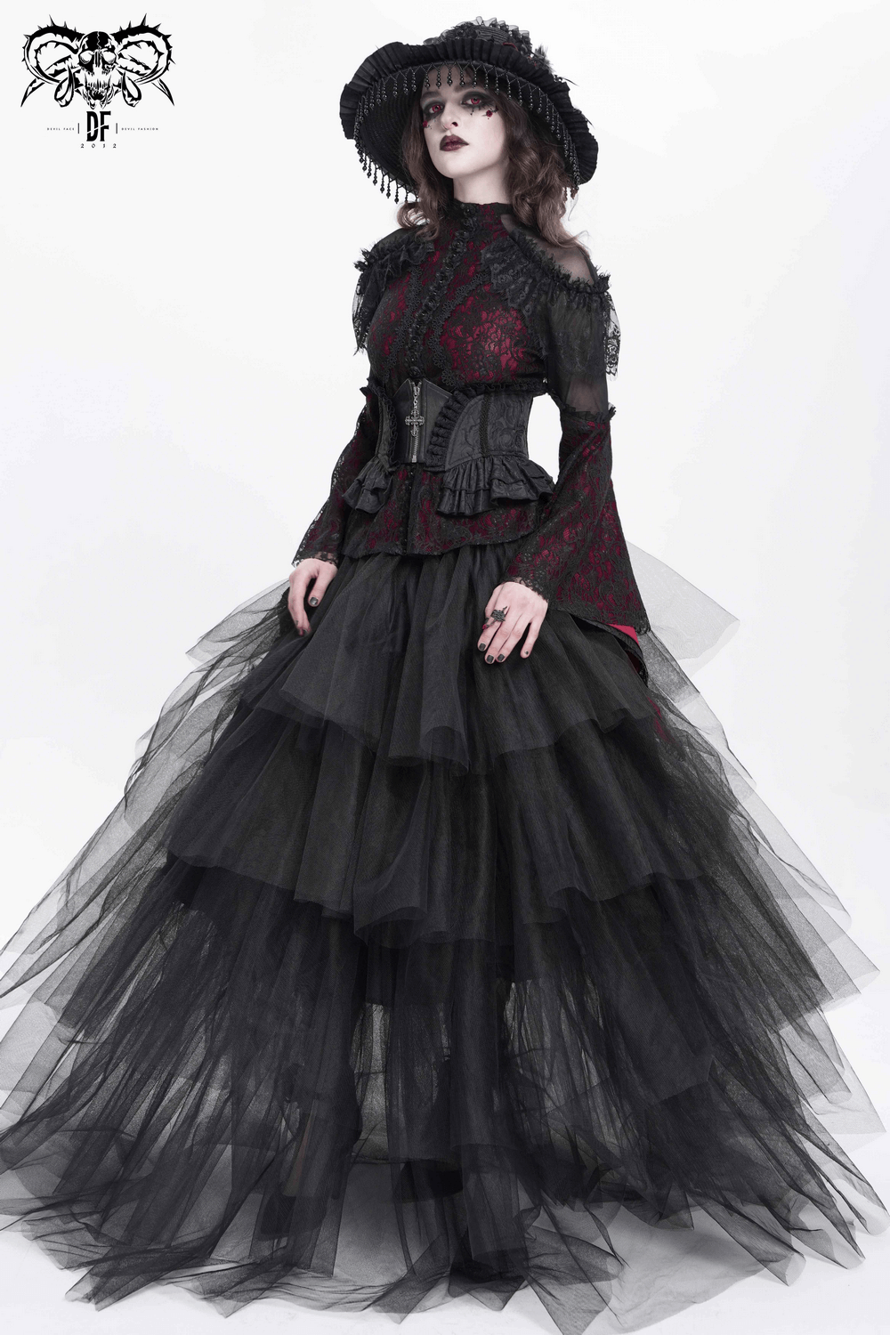 Model in a Gothic lace corset belt with a layered black tulle gown showcasing Victorian elegance.