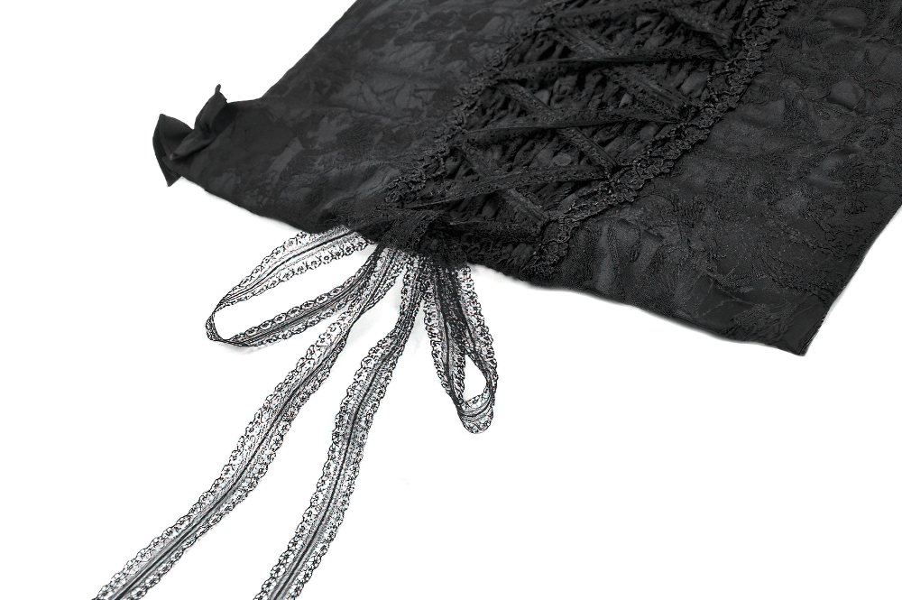 Close-up of lace corset top detailing with adjustable black ribbon straps and intricate brocade design.