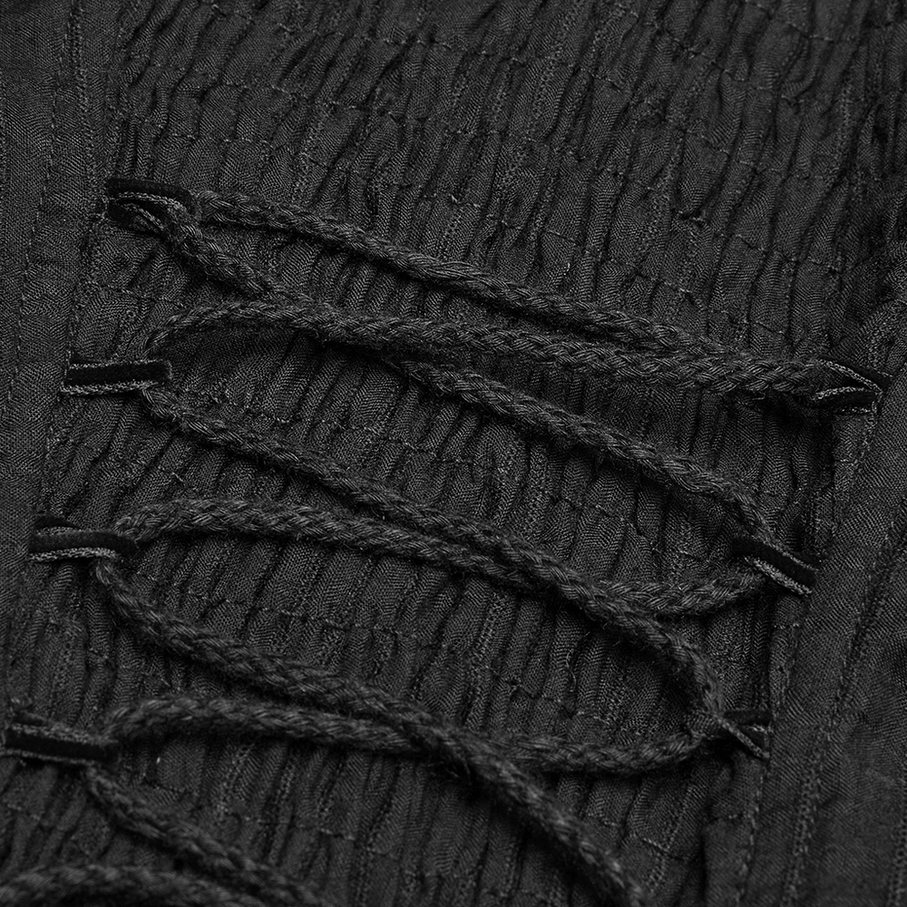 Close-up of Gothic lace dress detailing featuring intricate black lace and textured fabric with elegant stitching.