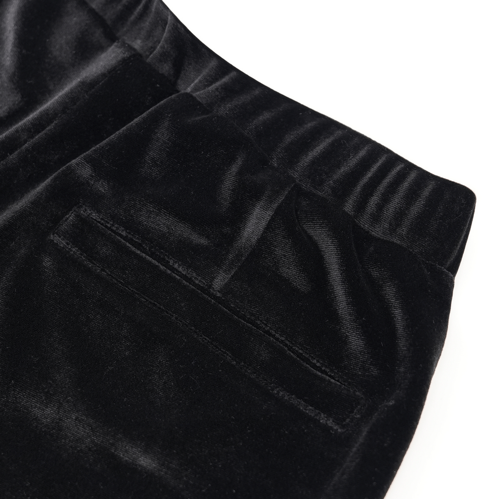 Close-up of black velvet fabric showcasing elastic waistband and pocket detail for gothic flare pants.