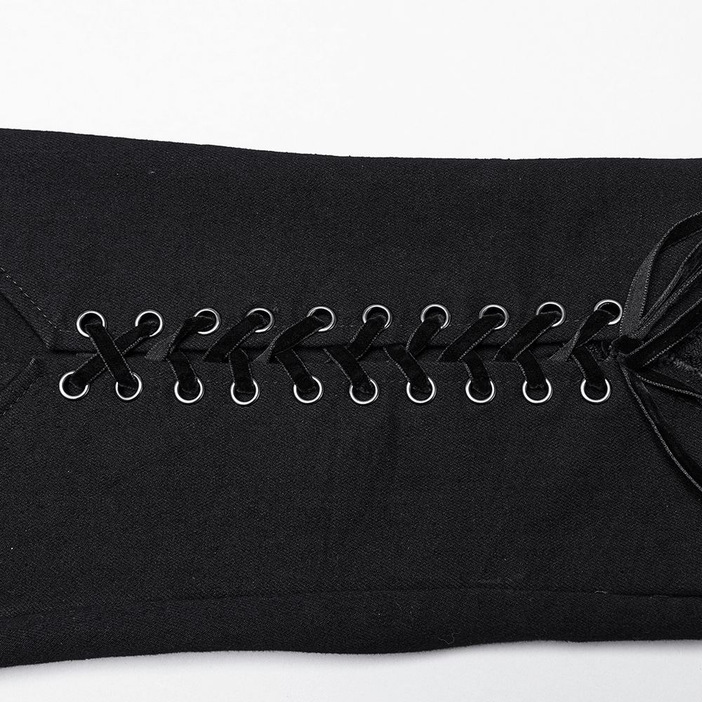 Close-up of Gothic lace-up detailing on black low-waisted pants with V-shaped drawstring.