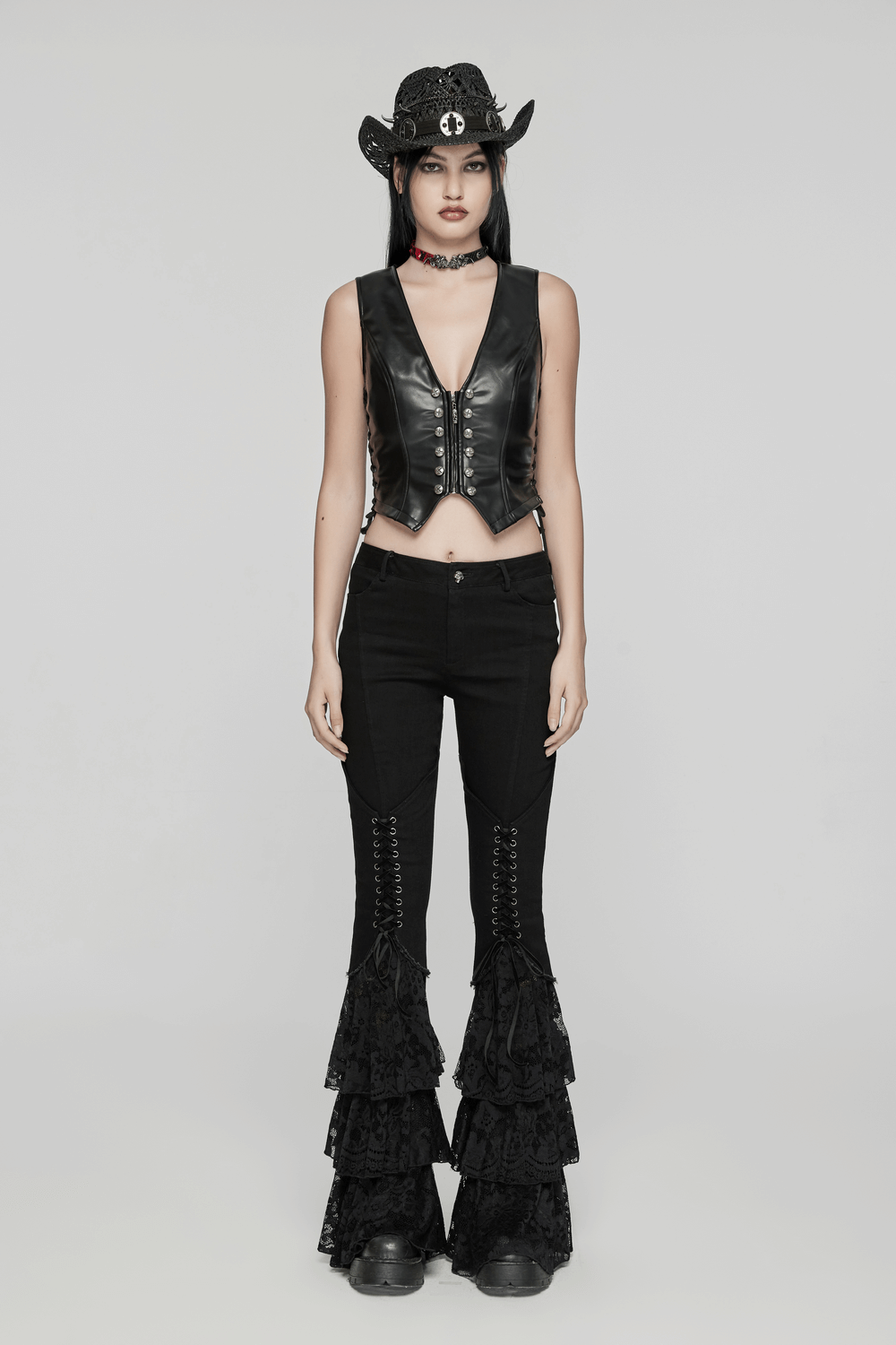 Model wearing Gothic Lace Flared Pants with V-shaped drawstring and edgy leather vest, showcasing a punk rock style.