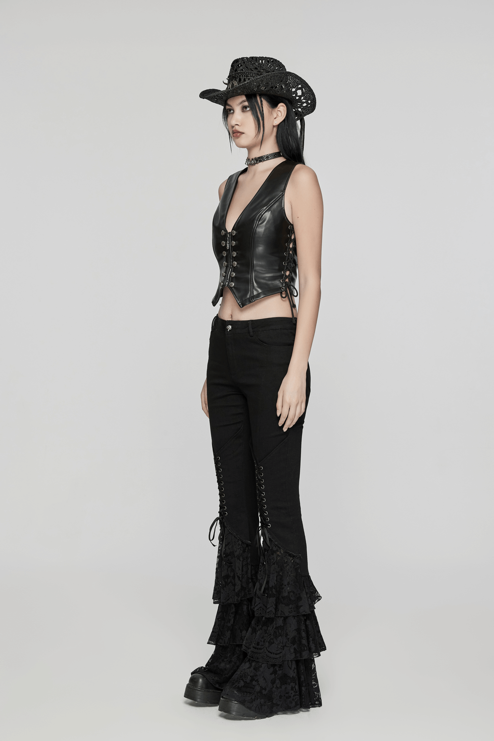 Model showcasing Gothic Lace Flared Pants with V-shaped drawstring and leather vest, embodying edgy punk style.