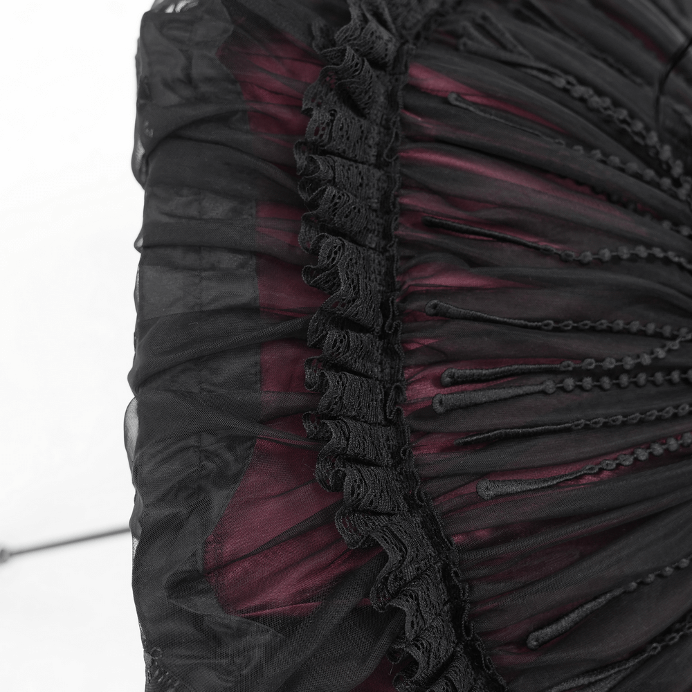 Close-up of gothic lace umbrella fringe, showcasing intricate black lace and satin detail for vintage elegance.