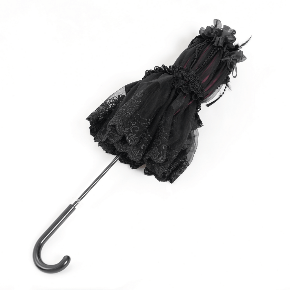 Vintage-inspired black lace fringe umbrella with roses and satin detail, perfect for gothic elegance.