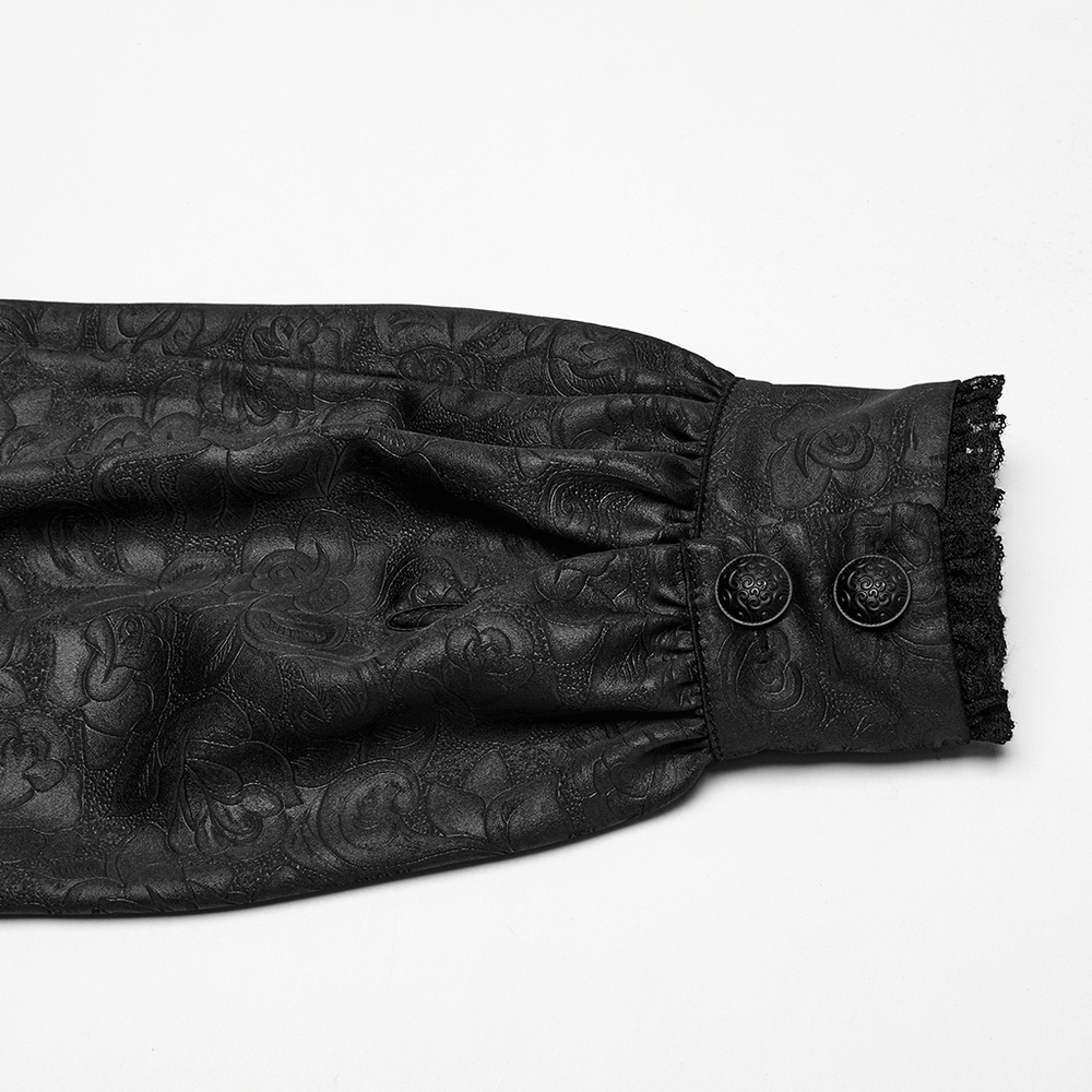 Close-up of gothic lace sleeve, featuring elegant black fabric and intricate dark rose pattern with buttons.