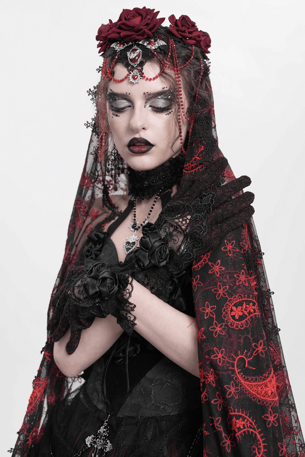 Gothic lace gloves paired with a dramatic black and red ensemble, featuring roses and intricate details for a vintage look.
