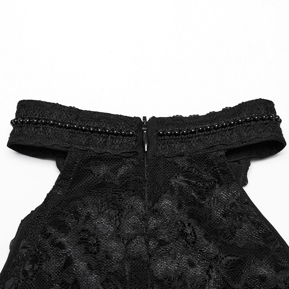 Close-up of Gothic lace halter neck top showing black lace, pleated detail, and decorative beaded zipper.