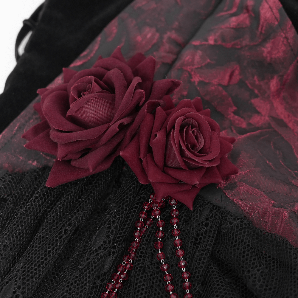 Close-up of gothic lace top featuring burgundy roses and beaded chains, showcasing elegant velvet and lace details.