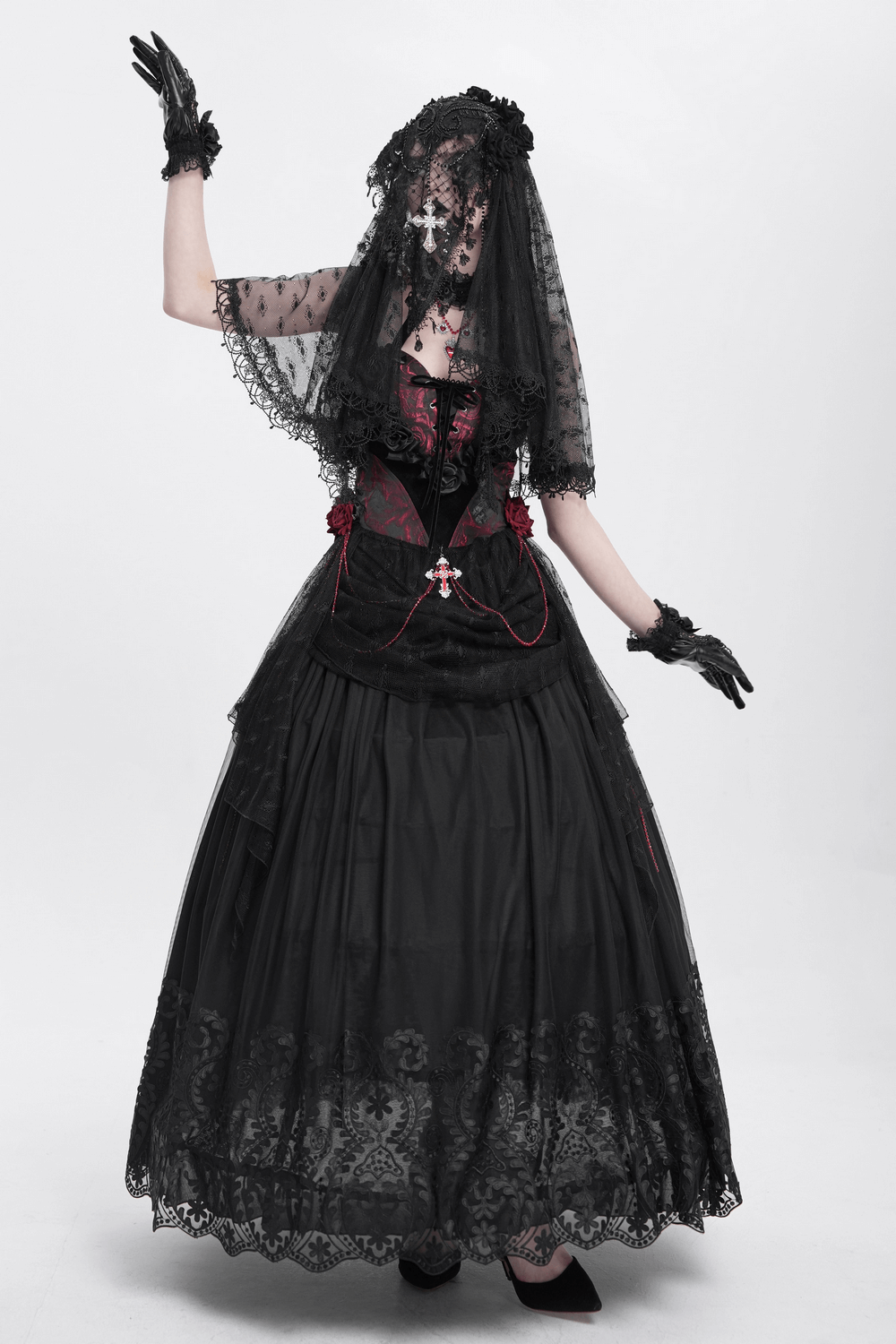 Elegant gothic woman in black lace veil and gown, showcasing a dramatic Victorian-inspired look.