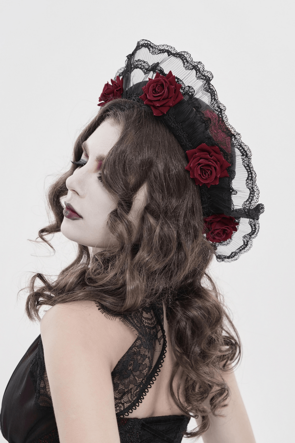 Gothic Lace Hat with Burgundy Roses and Veil Trim worn by a model showcasing its dramatic style and intricate details.