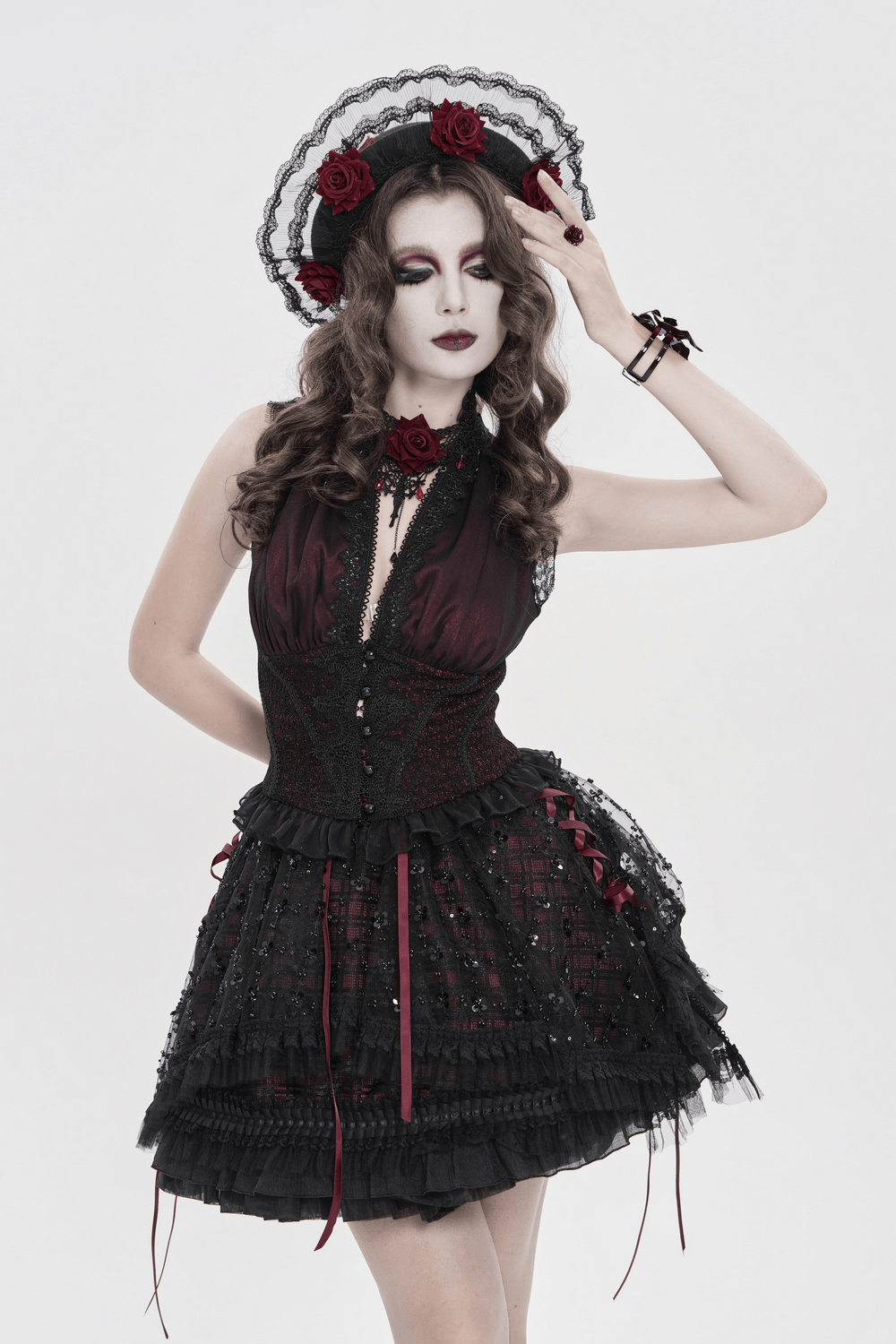 Gothic Lace Hat with Burgundy Roses and Veil Trim worn with a vintage-inspired black and red dress for dramatic effect.