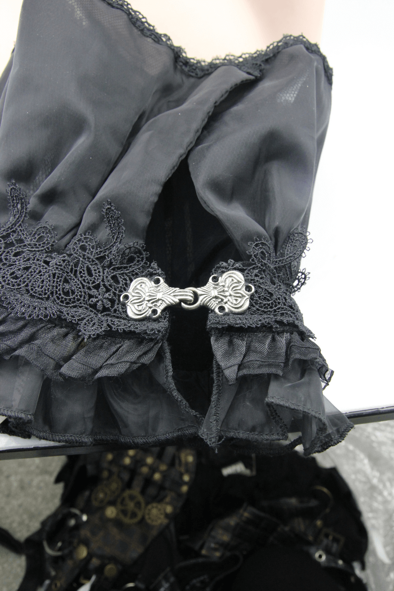 Close-up of a black gothic lace collar with decorative silver brooch and frills, perfect vintage accessory for women.