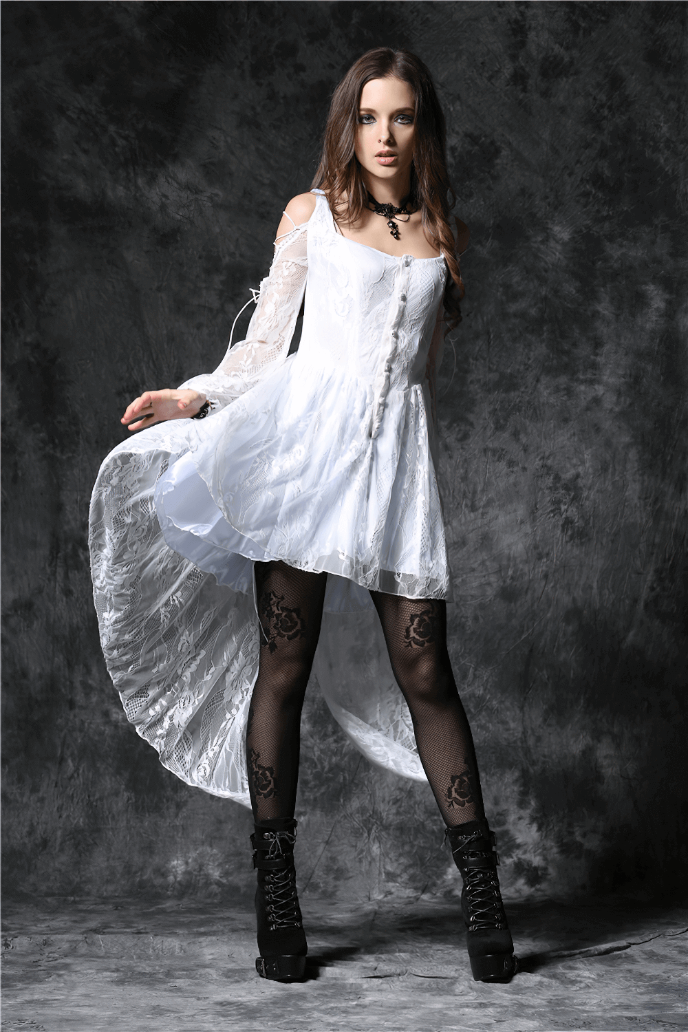 Gothic lace high-low white dress with sheer sleeves, dramatic hem, and black tights for a stylish gothic look.