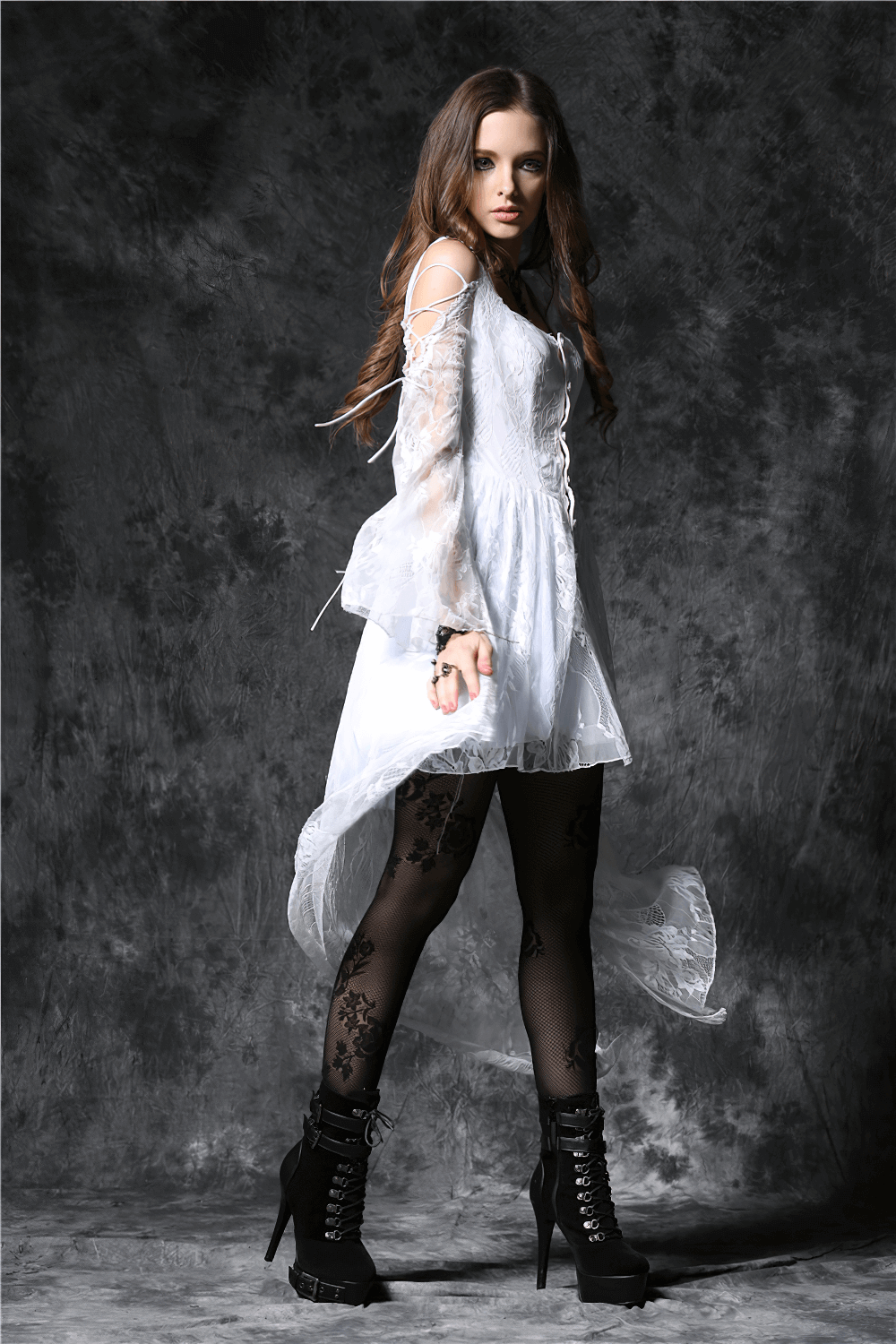 Gothic lace high-low dress with sheer sleeves and black leggings, perfect for a night out or special occasion.