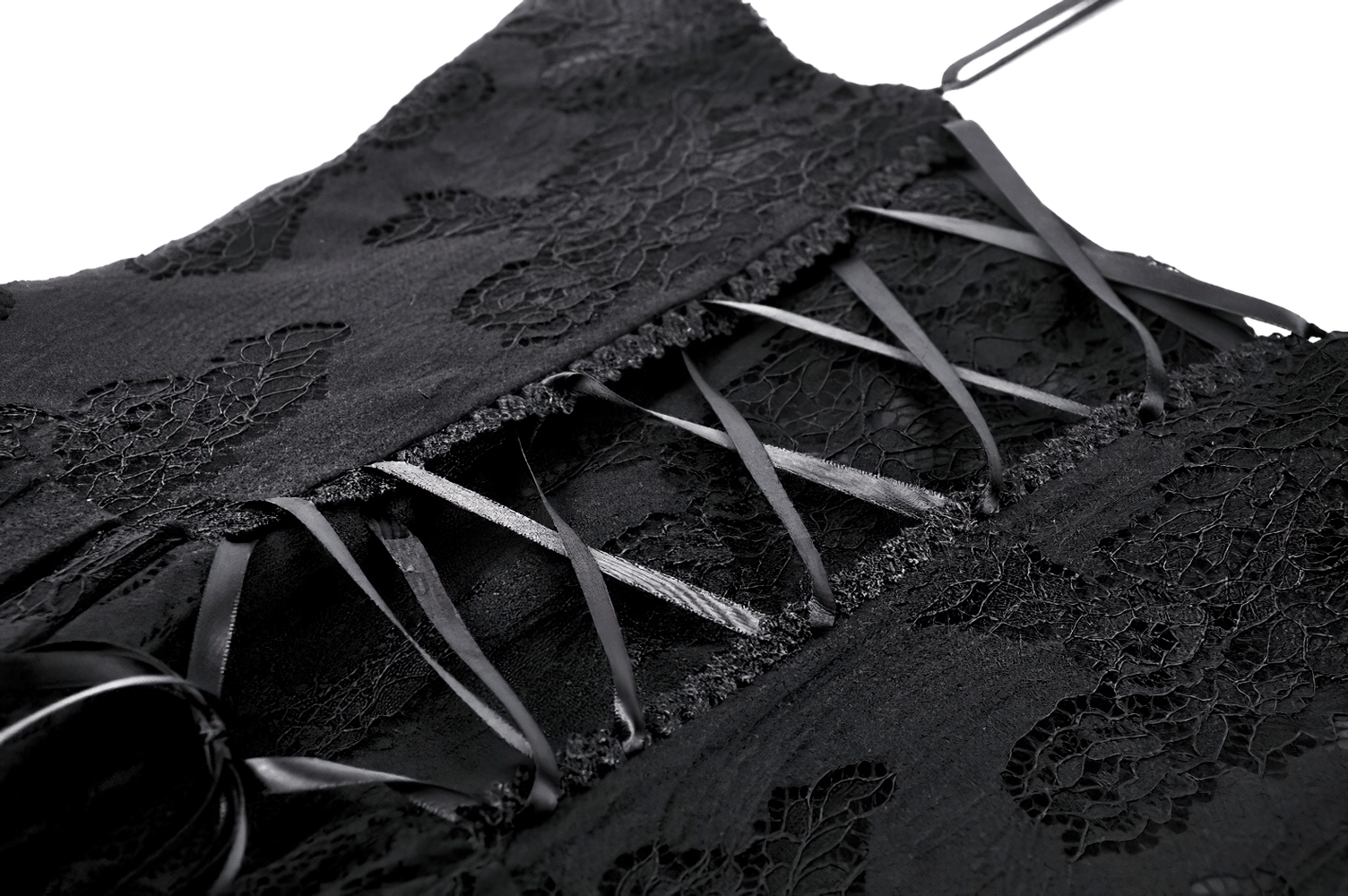 Close-up of gothic black lace dress straps with intricate detailing and rose motif.