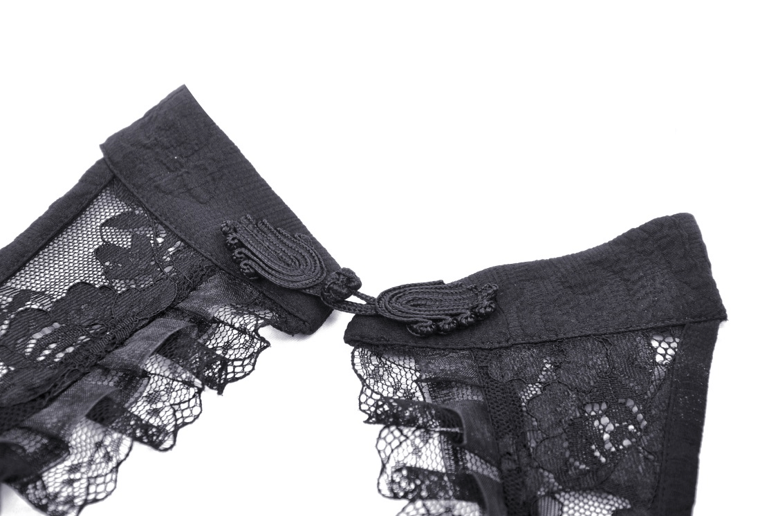 Close-up of the intricate lace detailing and closure of a gothic lace halter dress.