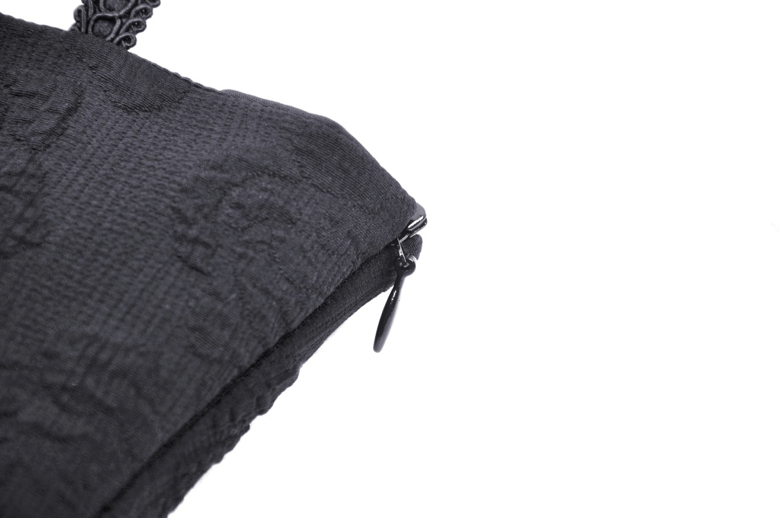 Detail of the gothic lace halter dress showing intricate fabric texture and zipper.