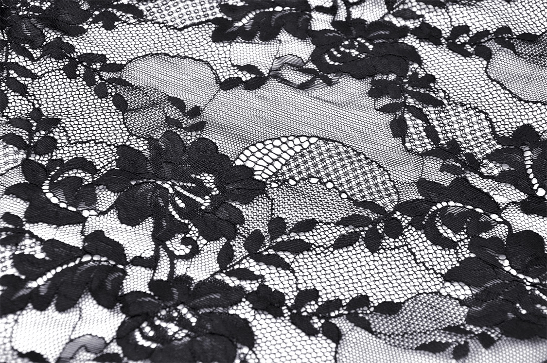 Intricate black lace fabric featuring floral patterns and ghostly skull designs, perfect for gothic fashion.