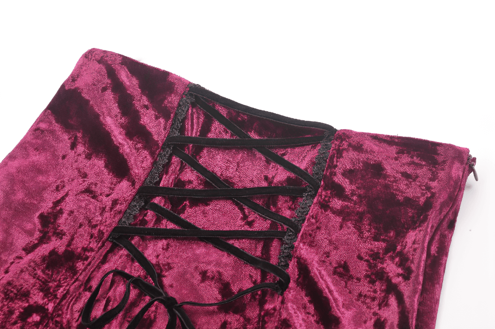 Close-up of burgundy velvet corset lacing on a gothic high-low skirt, showcasing intricate design and texture.