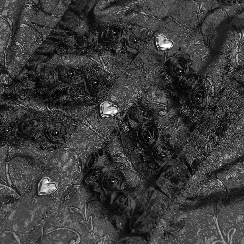 Close-up of gothic blouse's floral jacquard fabric with heart-shaped buttons and lace details.