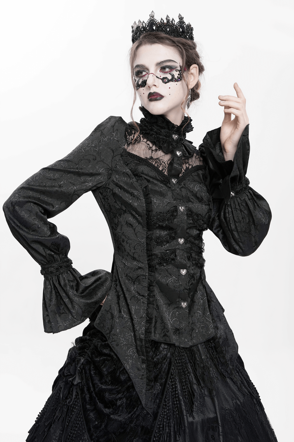 Victorian-inspired gothic blouse with lace, puff sleeves, and heart buttons, paired with a black lace skirt.