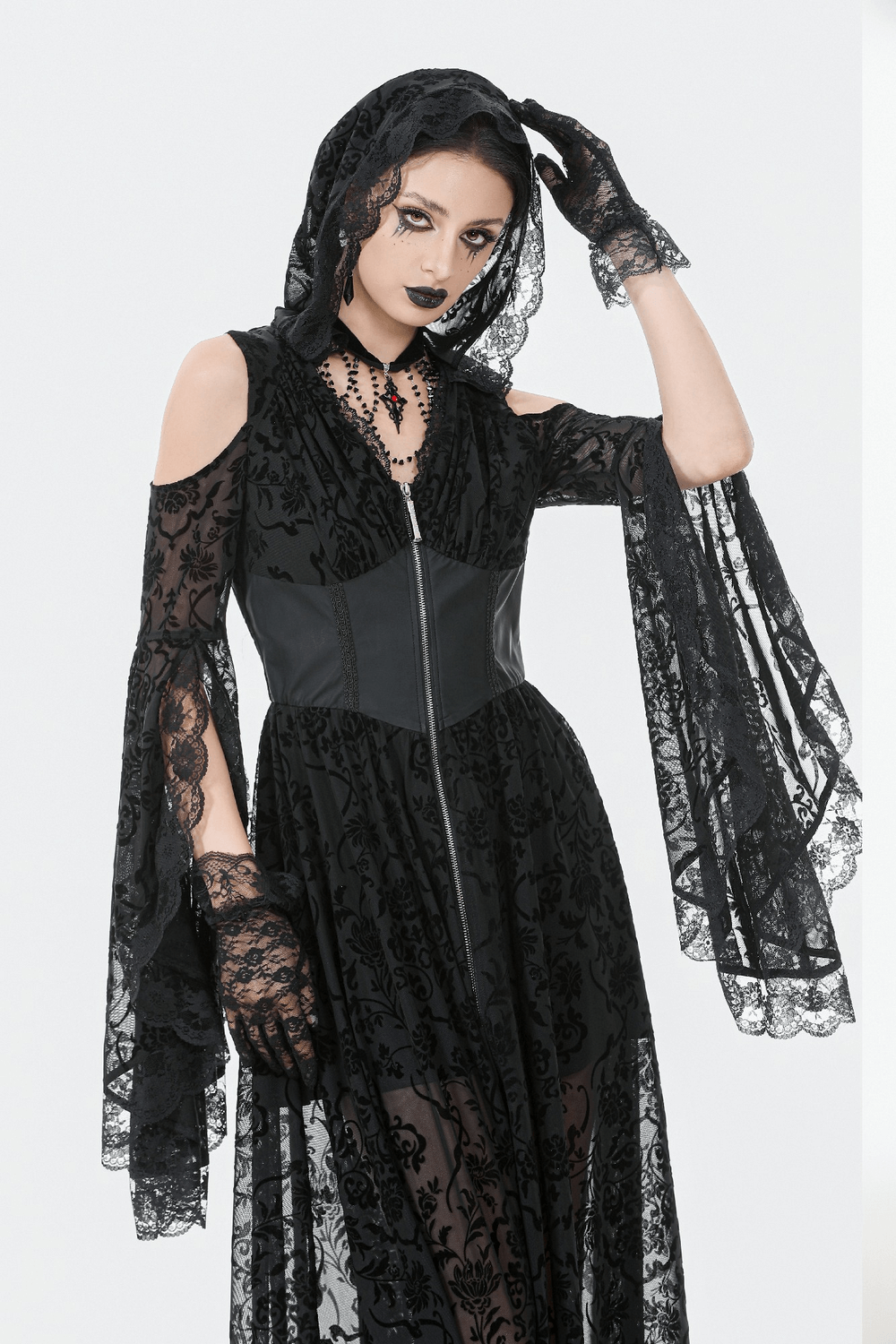 Gothic Lace Hooded Cold Shoulder Maxi Dress With Zip Closure modeled by a dark aesthetic model with lace details.