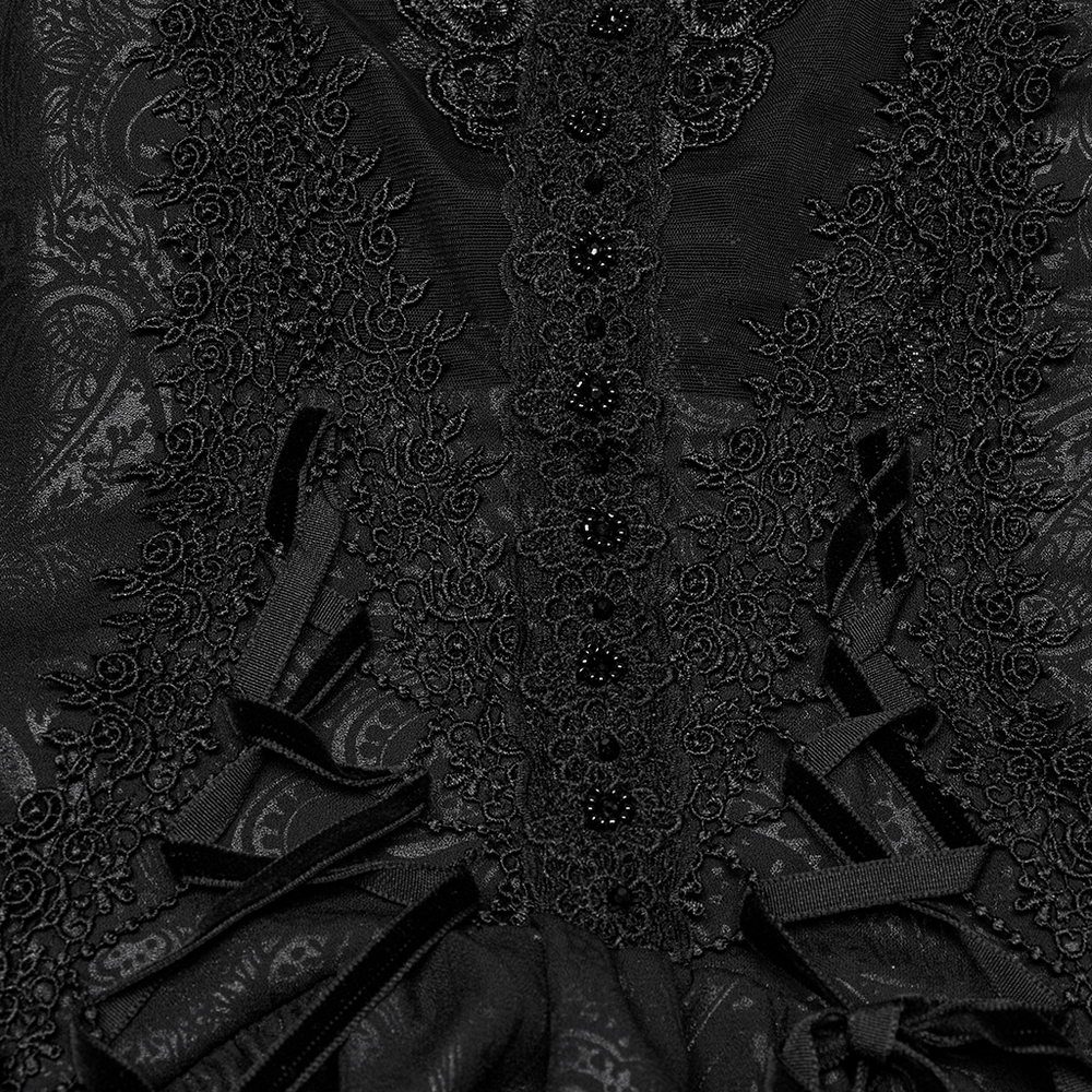 Close-up of gothic lace detailing on a black maxi dress, featuring intricate embroidery and ruffled elements.