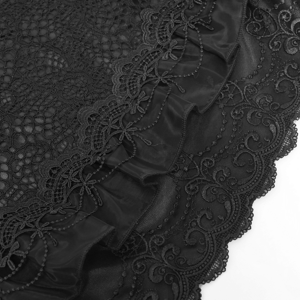 Close-up of black lace with floral embroidery and ruffled trim, perfect for gothic or steampunk fashion.