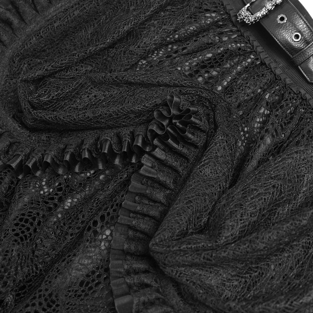 Close-up of black lace layered skirt showcasing ruffled drapes, intricate trim, and buckle detail for gothic style.