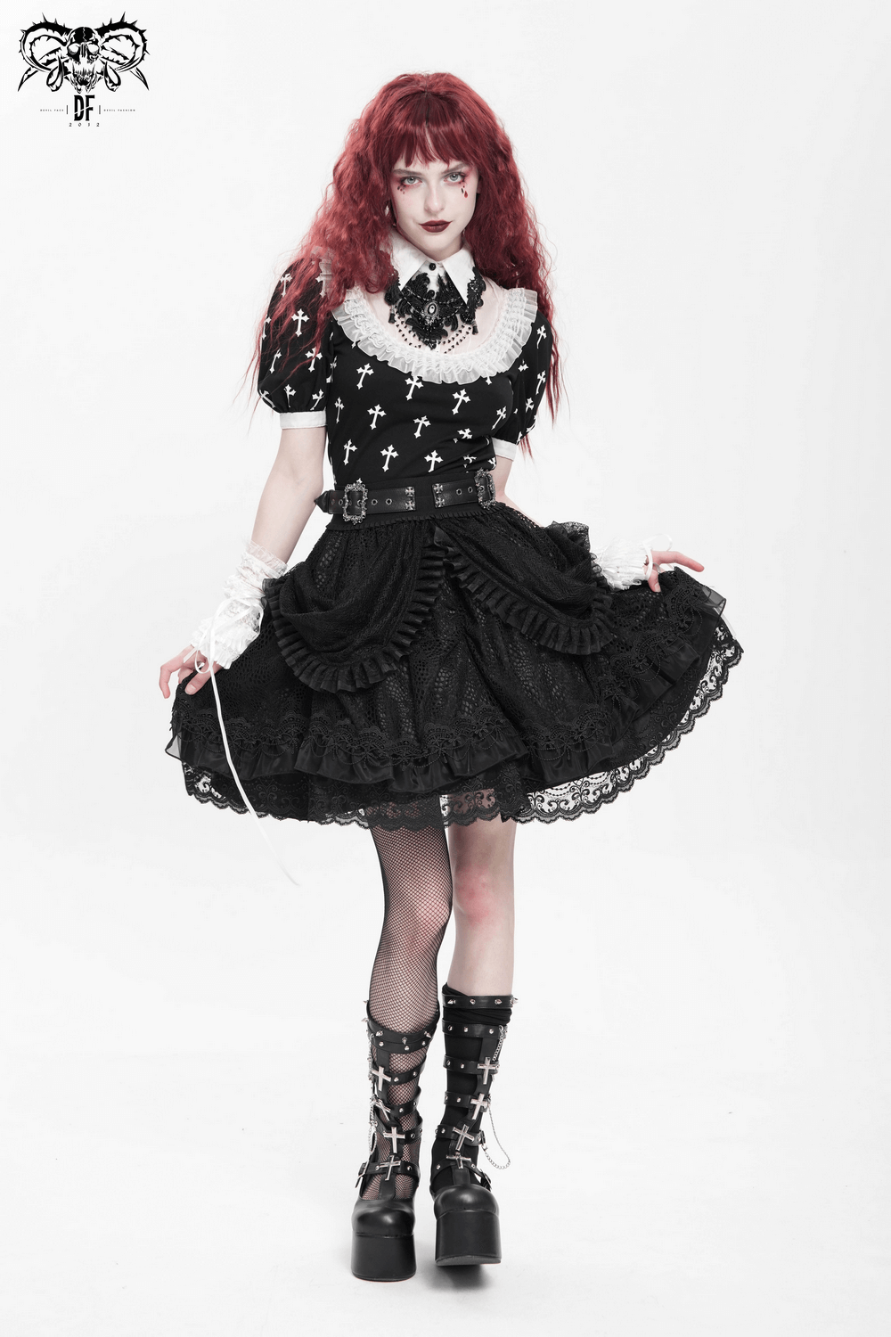 Gothic lace skirt with ruffled layers, paired with a cross-pattern blouse and statement accessories.