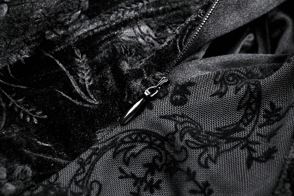 Close-up of a black lace fabric showcasing intricate patterns and a zipper detail, perfect for gothic attire.