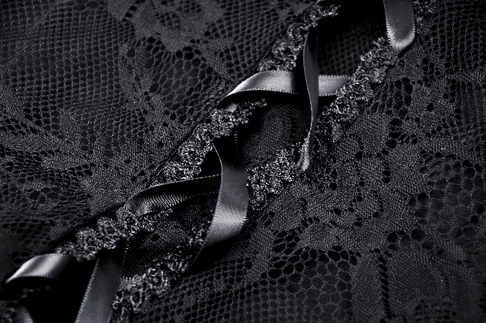 Close-up of gothic lace fabric featuring corset back detailing with black satin ribbons.