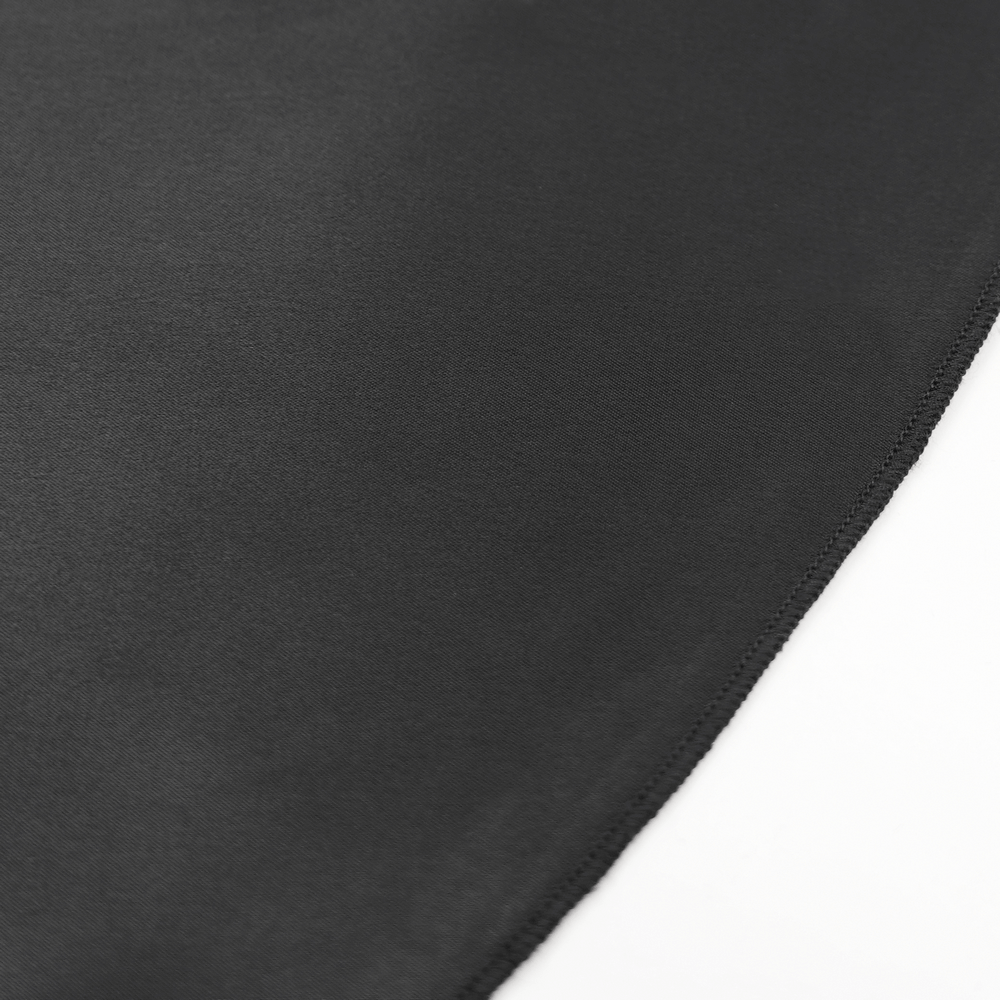 Close-up of smooth black satin fabric showcasing elegant texture for Gothic fashion.