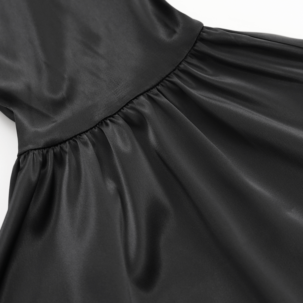 Close-up of black satin fabric detail showcasing elegant draping and smooth texture, perfect for gothic fashion.