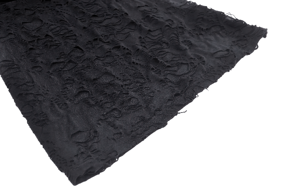 Close-up of sheer black ripped fabric showcasing intricate textures for gothic fashion.