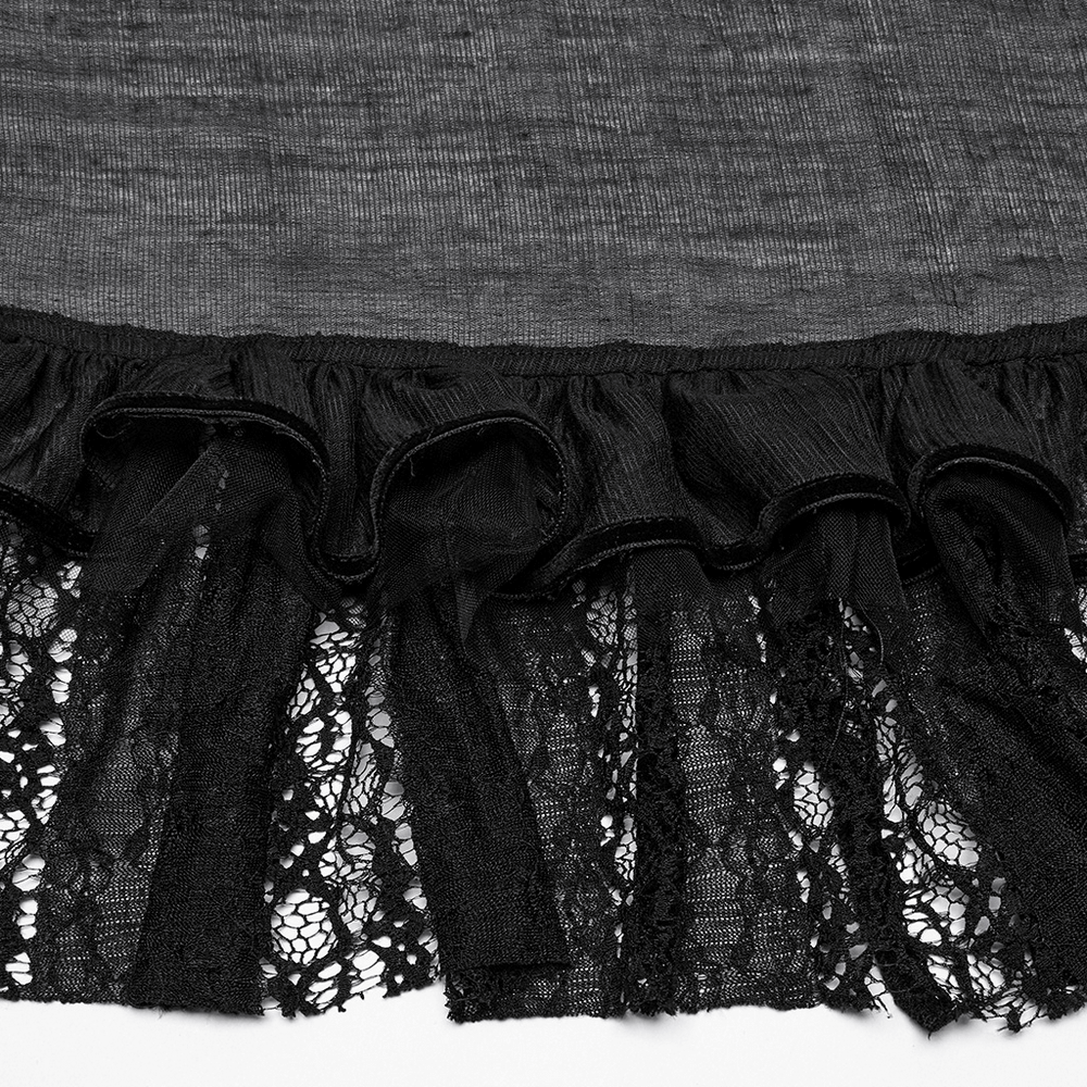 Close-up of gothic lace and chiffon ruffles on high-low skirt, showcasing elegant black design and texture details.