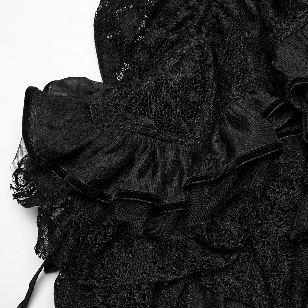 Close-up of black gothic lace skirt with ruffled chiffon mesh, showcasing intricate lace details and flowing layers.