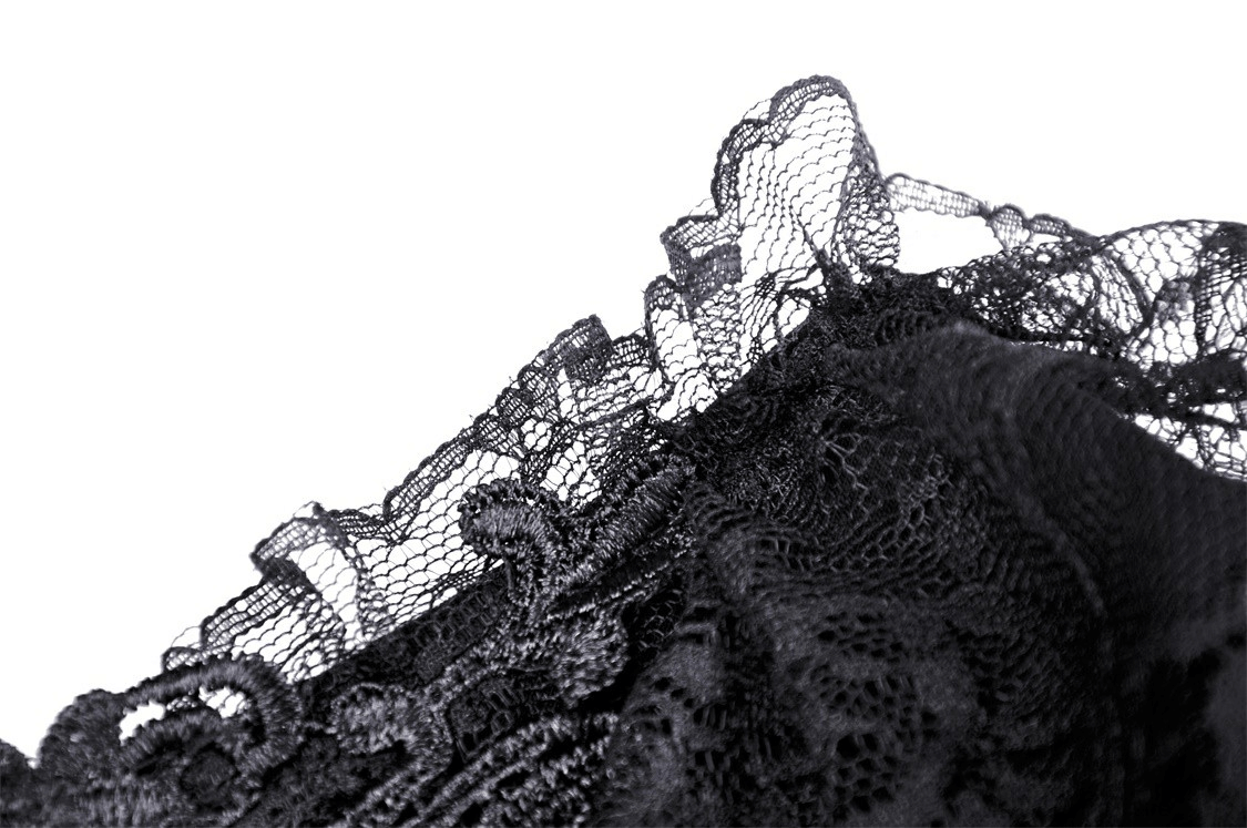 Close-up of black gothic lace with ruffled edges, showcasing intricate floral patterns and layered design details.