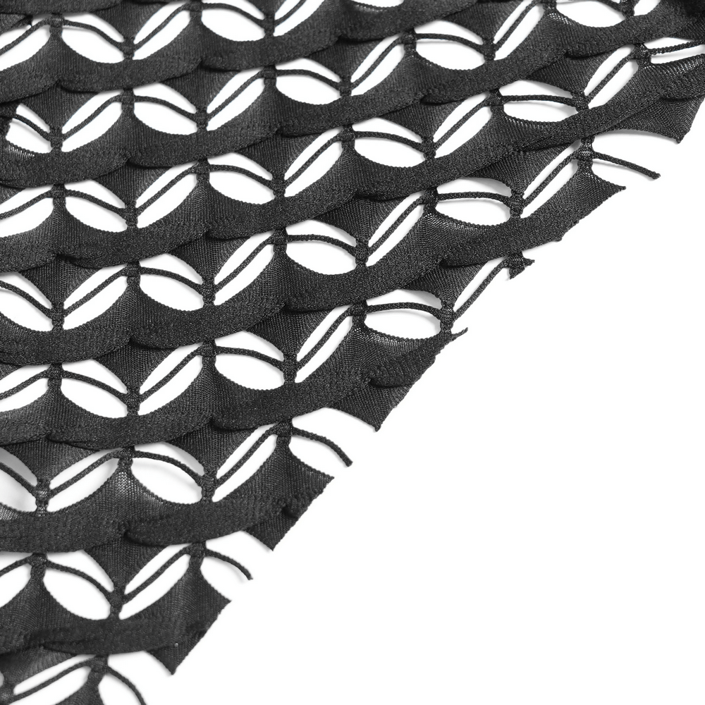 Close-up of intricate black lace mesh fabric with distinctive cut-out design, ideal for gothic and alternative fashion.