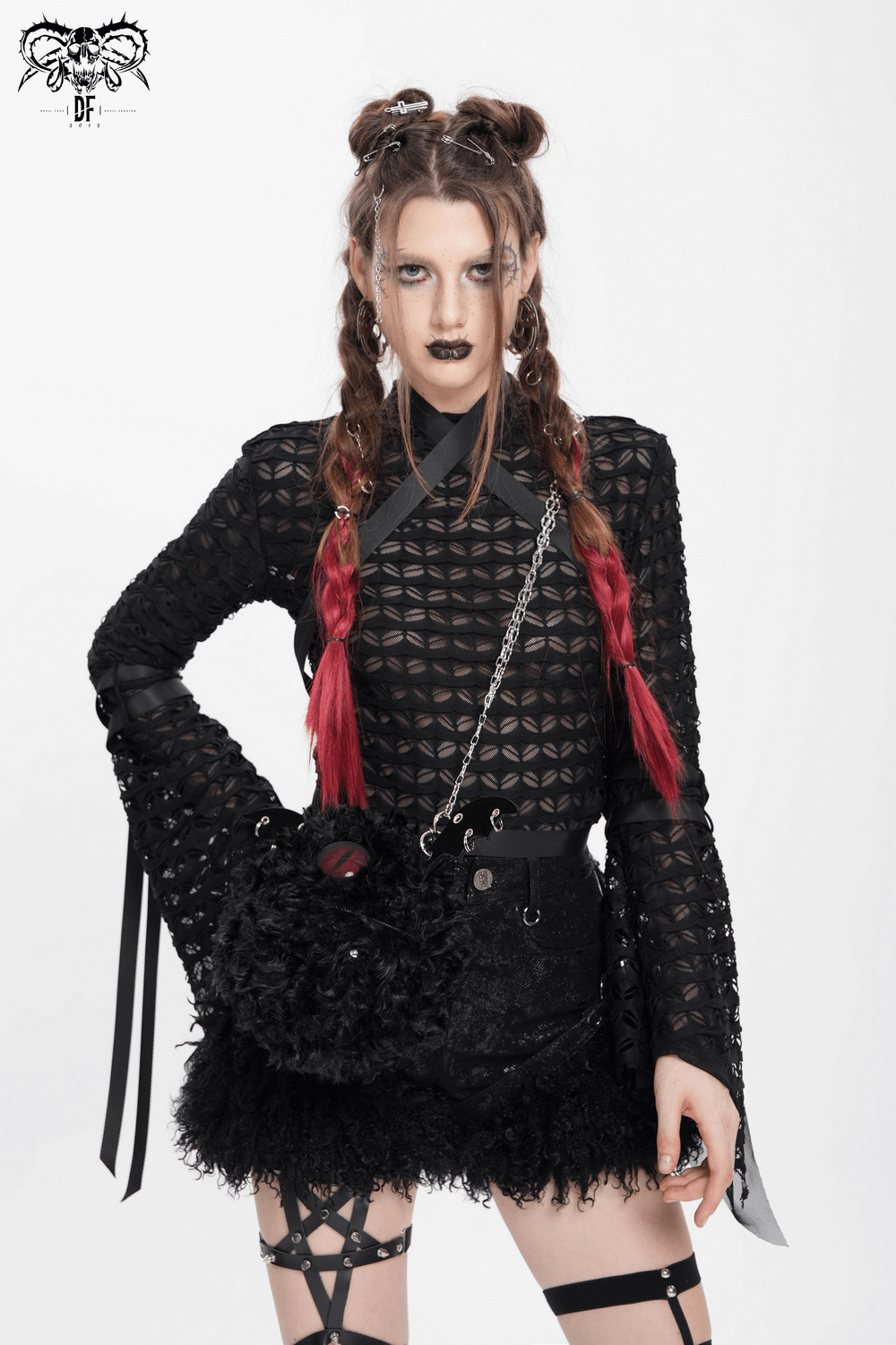 Gothic lace sheer top with flared sleeves and bold straps, styled with edgy accessories for alternative fashion.