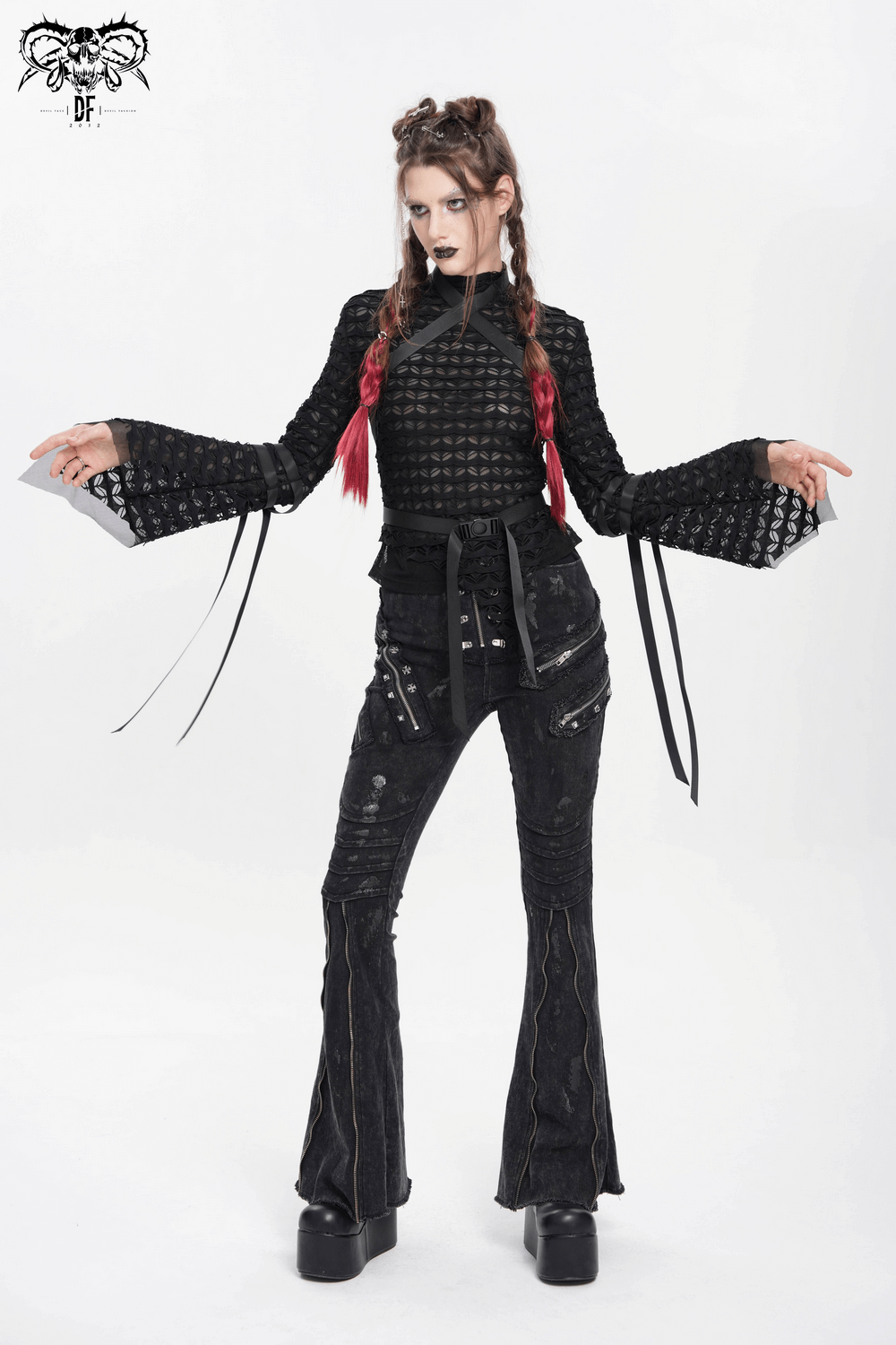Gothic lace sheer top with long flared sleeves and straps, styled with black trousers for an alternative fashion look.
