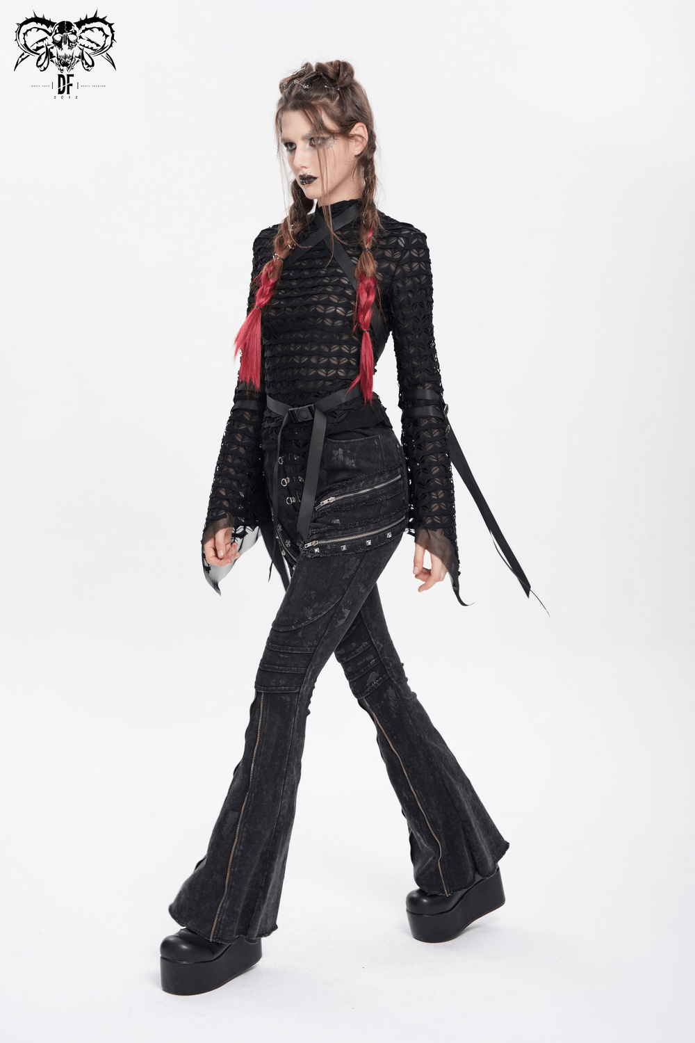 Gothic lace sheer top with straps, paired with flared pants, showcasing alternative fashion style.