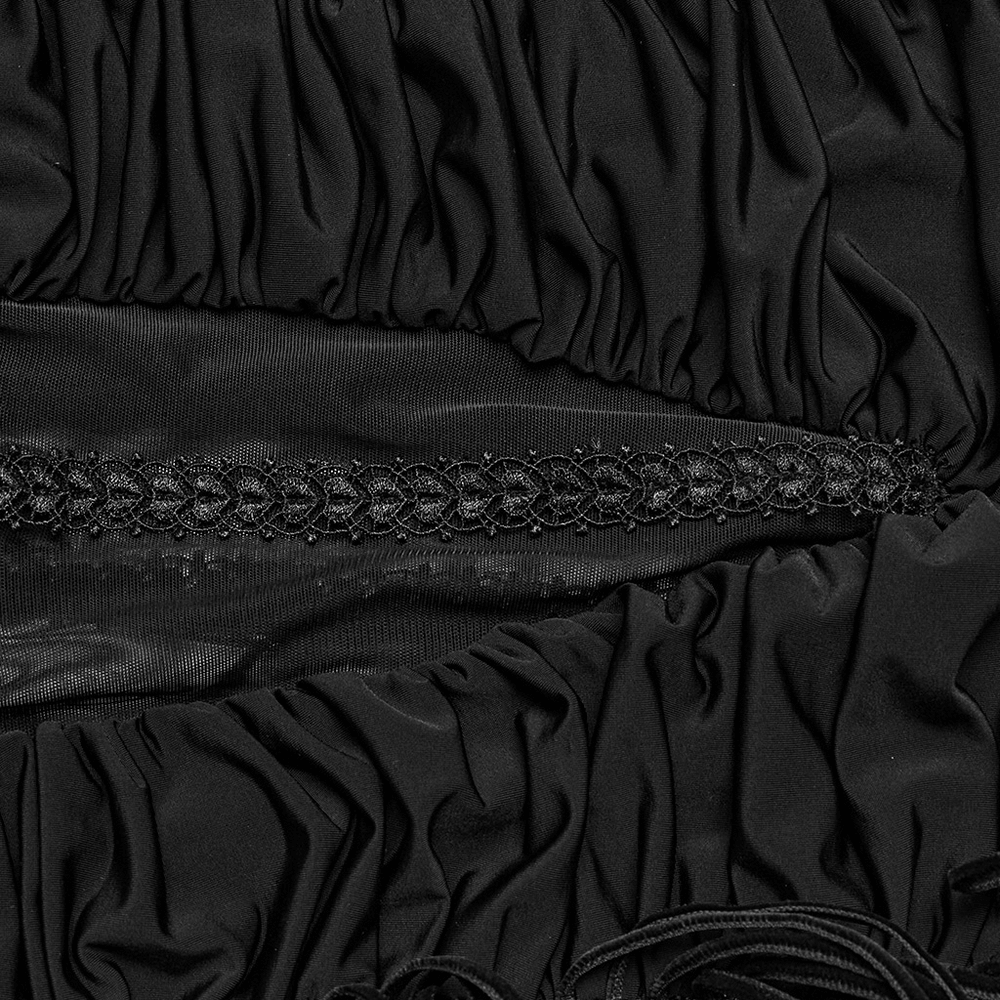 Close-up of black lace fabric showcasing intricate ruffles and decorative band detail for gothic long skirt.