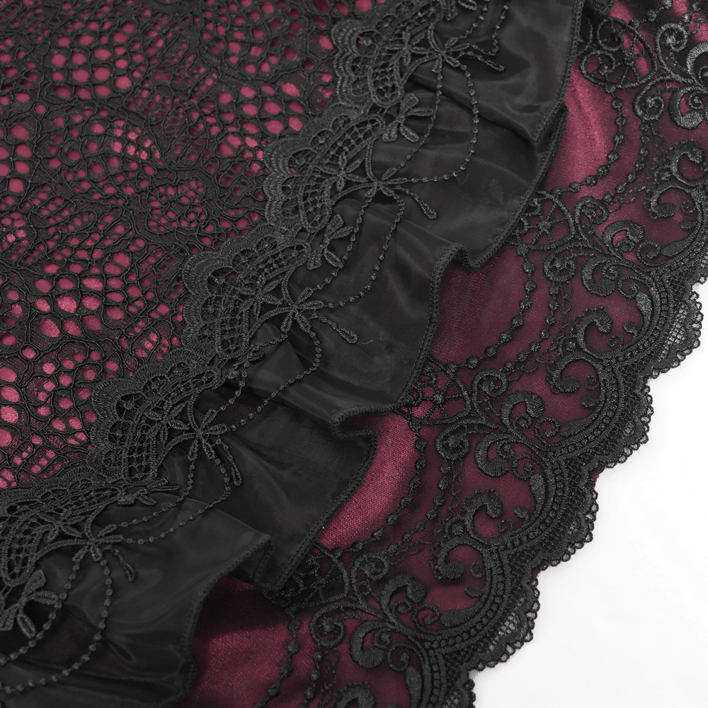 Gothic lace skirt detail with black ruffles and rich red underlayer, showcasing Victorian-inspired elegance.