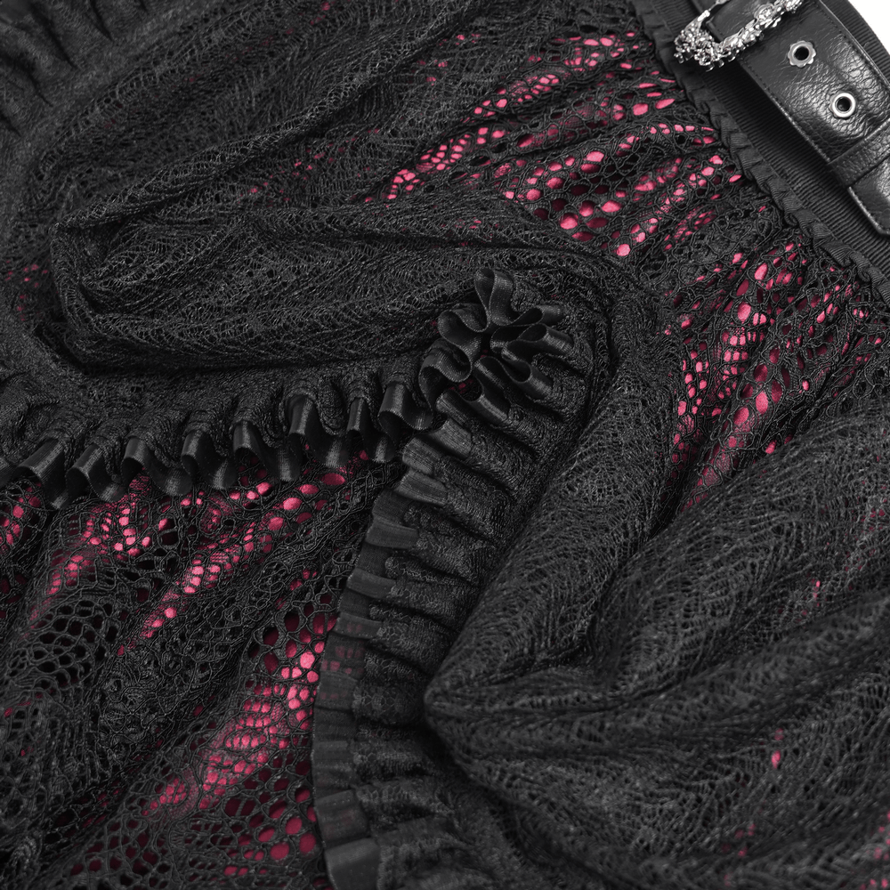 Close-up of gothic lace skirt showing black ruffles, intricate lace, and vibrant red underlayer, featuring a stylish belt.